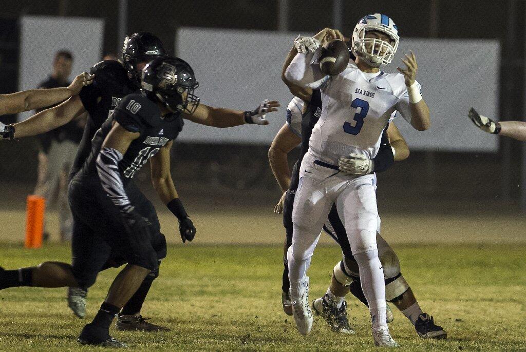 Corona del Mar High quarterback Chase Garbers is nearly sacked by Buena Park's Andrew Mulipola.