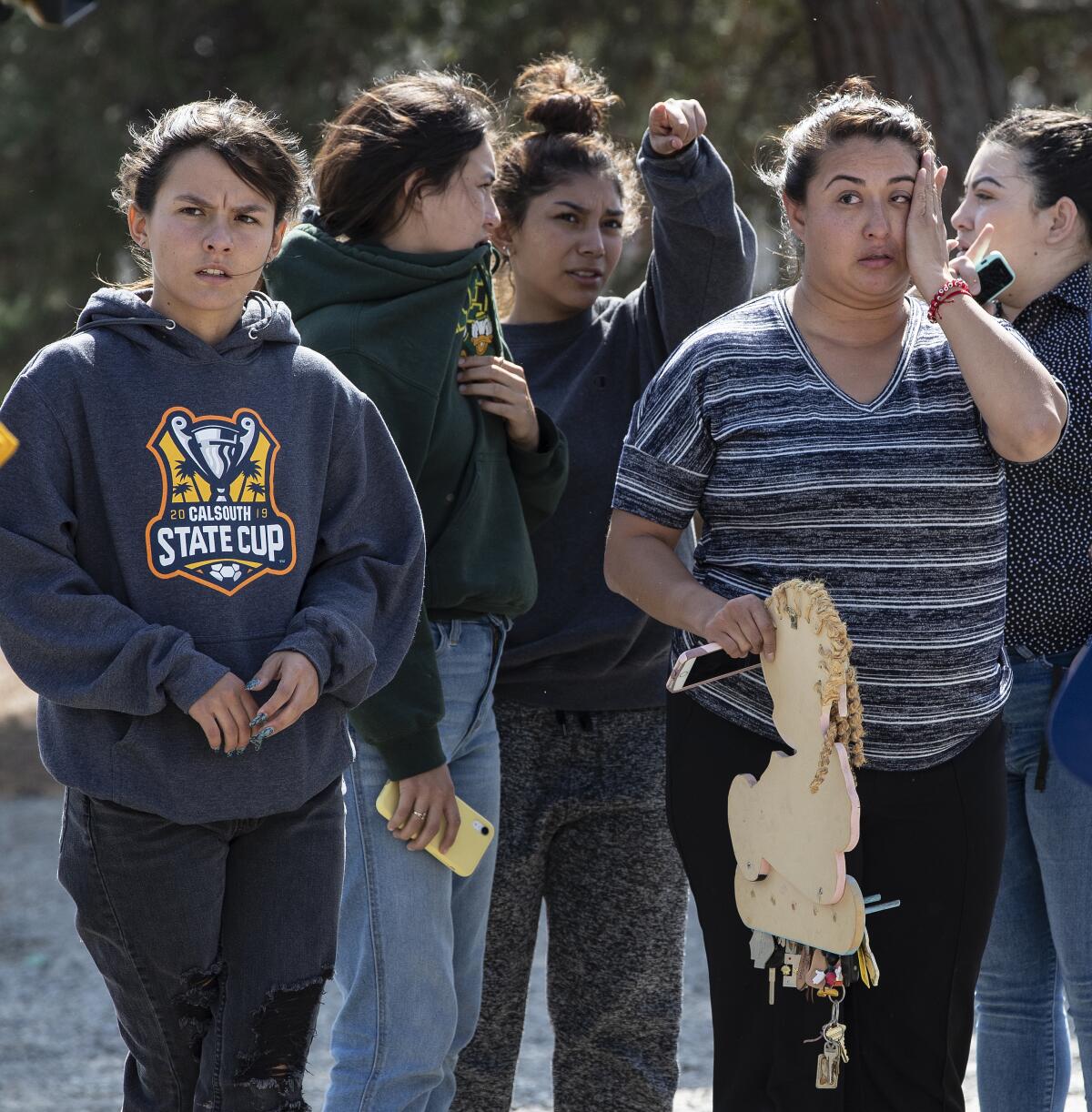 Residents wait after fleeing their home during a fire in Fontana