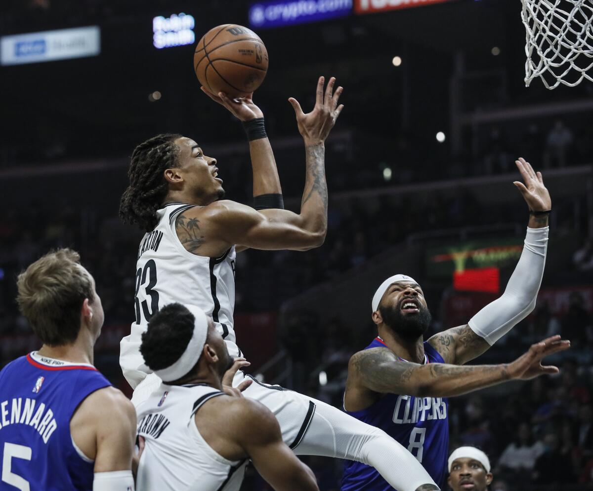 Brooklyn Nets forward Nic Claxton shoots over Clippers forward Marcus Morris Sr.