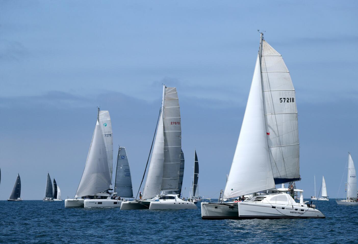 Under clearing skies, the ORCA class Voyager (7275), Wahoo (27070) and Kastor Pollux (57218) take off as the horn sounds for the start of their race, at the 2019 Newport To Ensenada International Yacht Race, off of Newport Beach, on Friday, April 26, 2019.