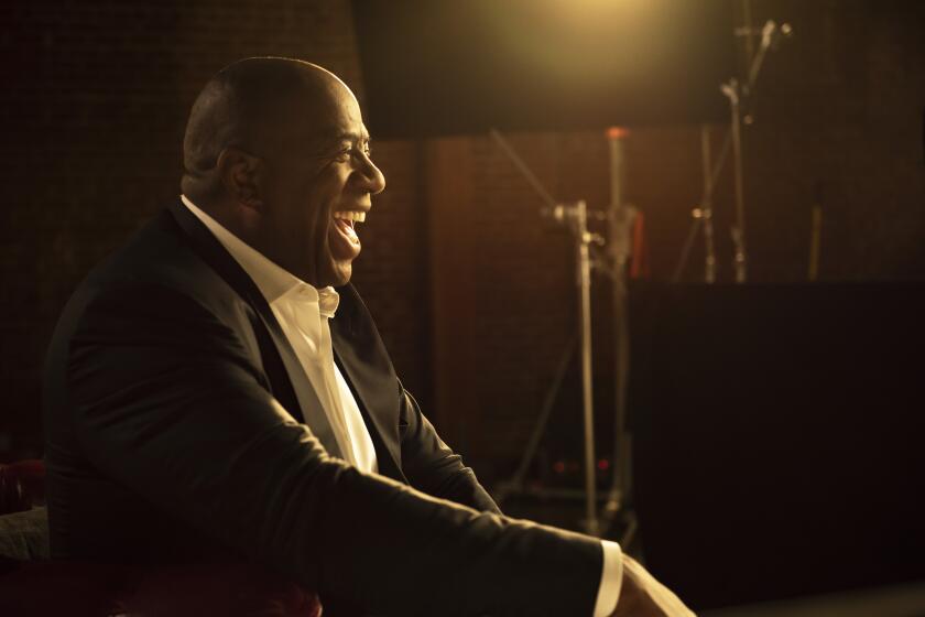 NBA star Magic Johnson laughing