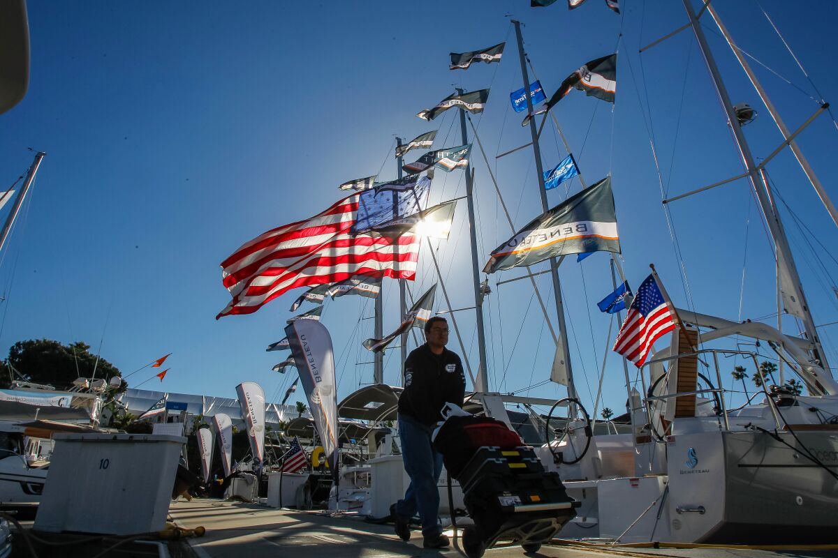 Flags are flying as crews prepare Wednesday for the Sunroad Marina Boat Show on Harbor Island in San Diego, California.