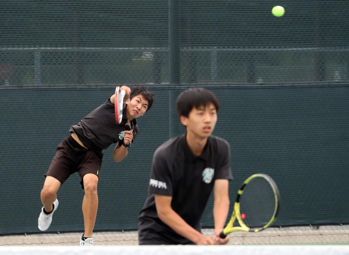 Sage Hill's No. 2 doubles players Evan Zhang, left, and Scott Hu, serve against Ayala.