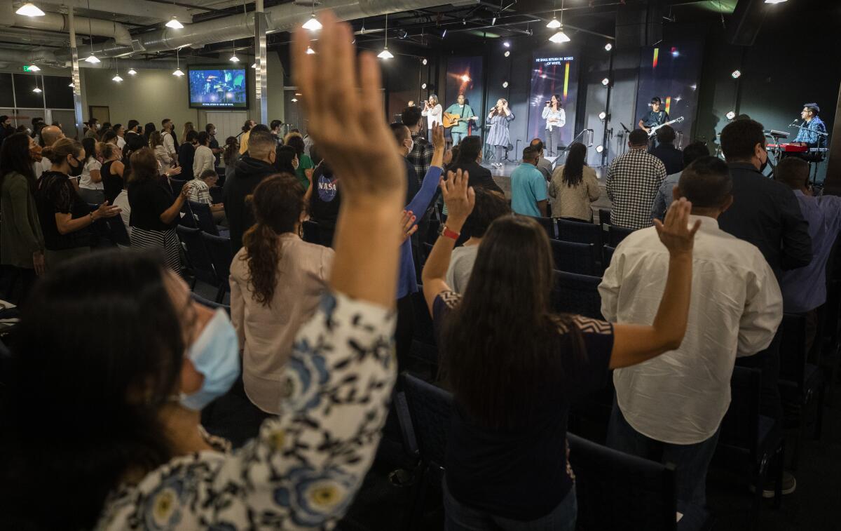 Worshippers attend a service at Houses of Light Church.