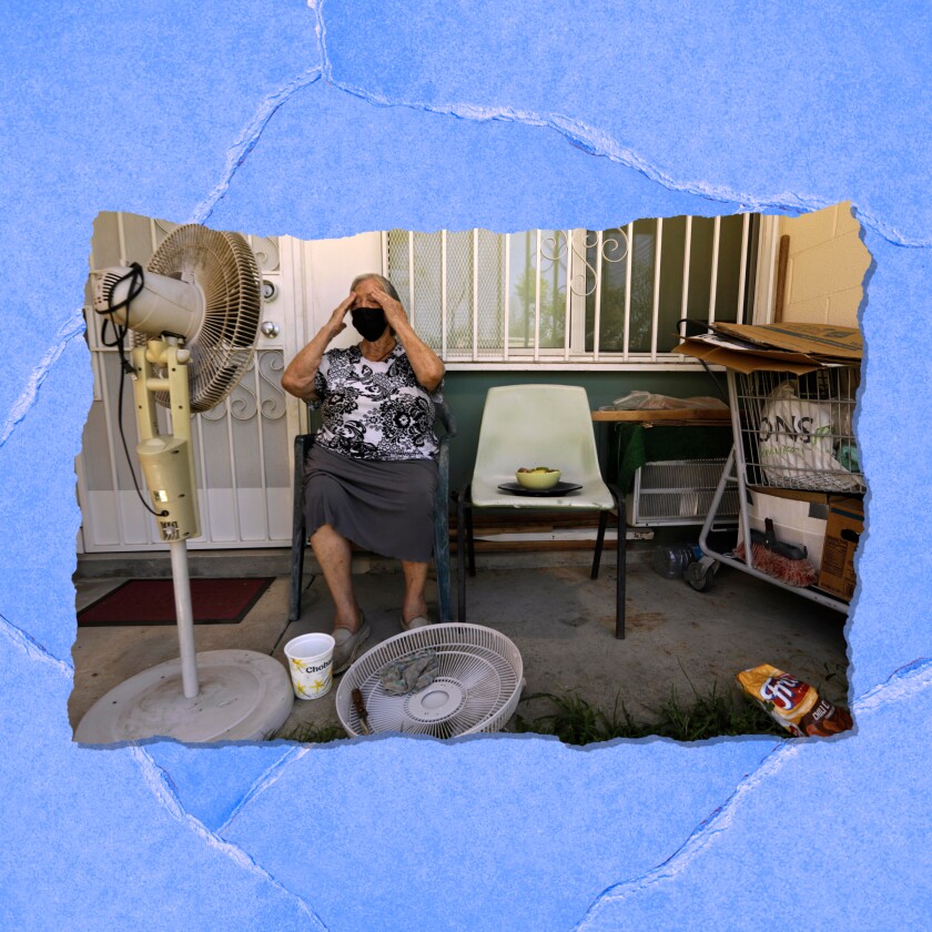 Woman before a fan in her home putting water on her face.