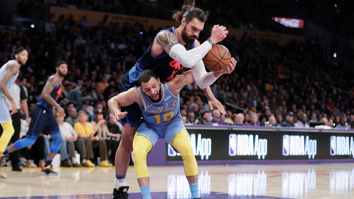 Oklahoma City Thunder center Steven Adams climbs over the back of Lakers forward Larry Nance Jr. for a second-half rebound at Staples Center on Wednesday.