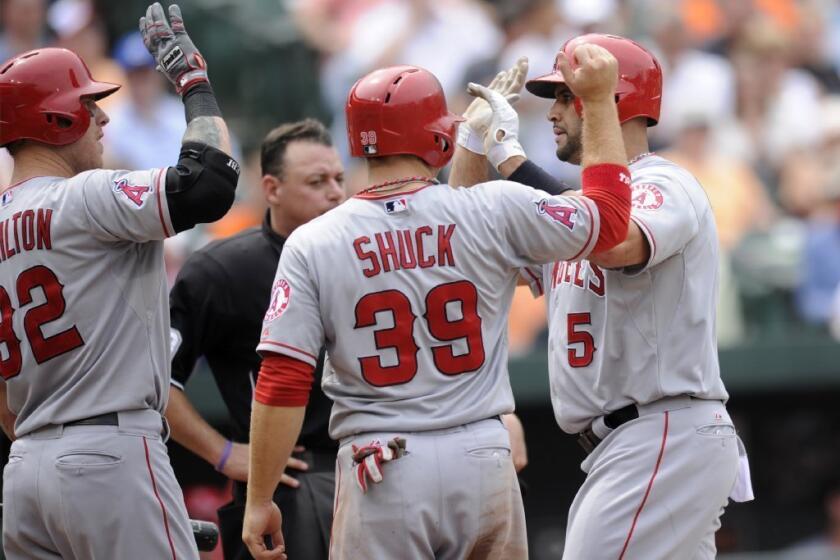 Albert Pujols, right, celebrates his two-run home run against Baltimore with teammates Josh Hamilton and J.B. Shuck during the seventh inning Wednesday.