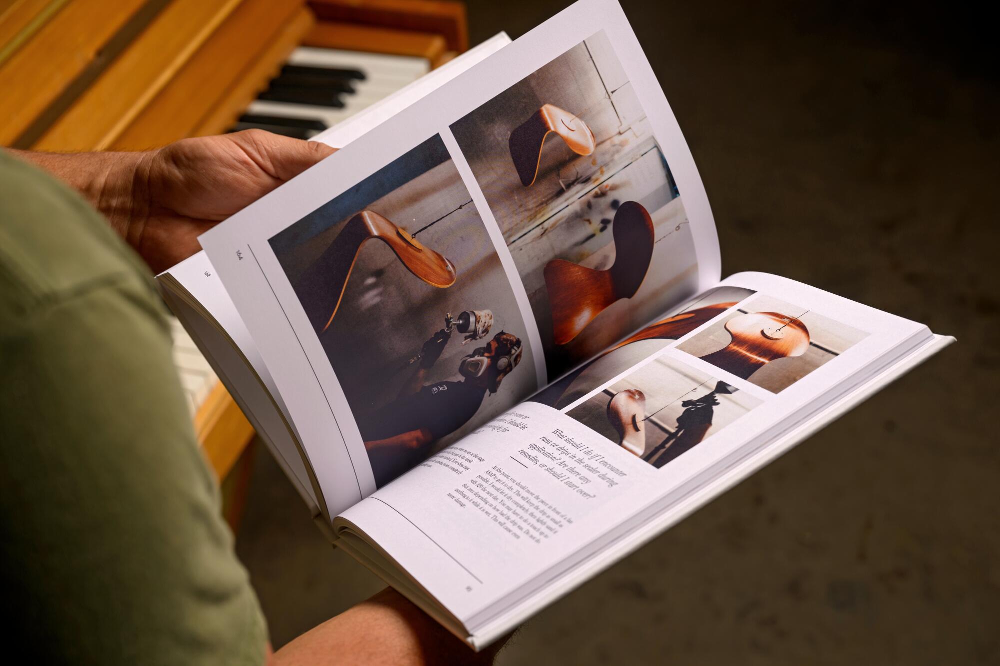 Aaron Moore flips through his book “Revive and Refine: The Art of Furniture Restoration.”