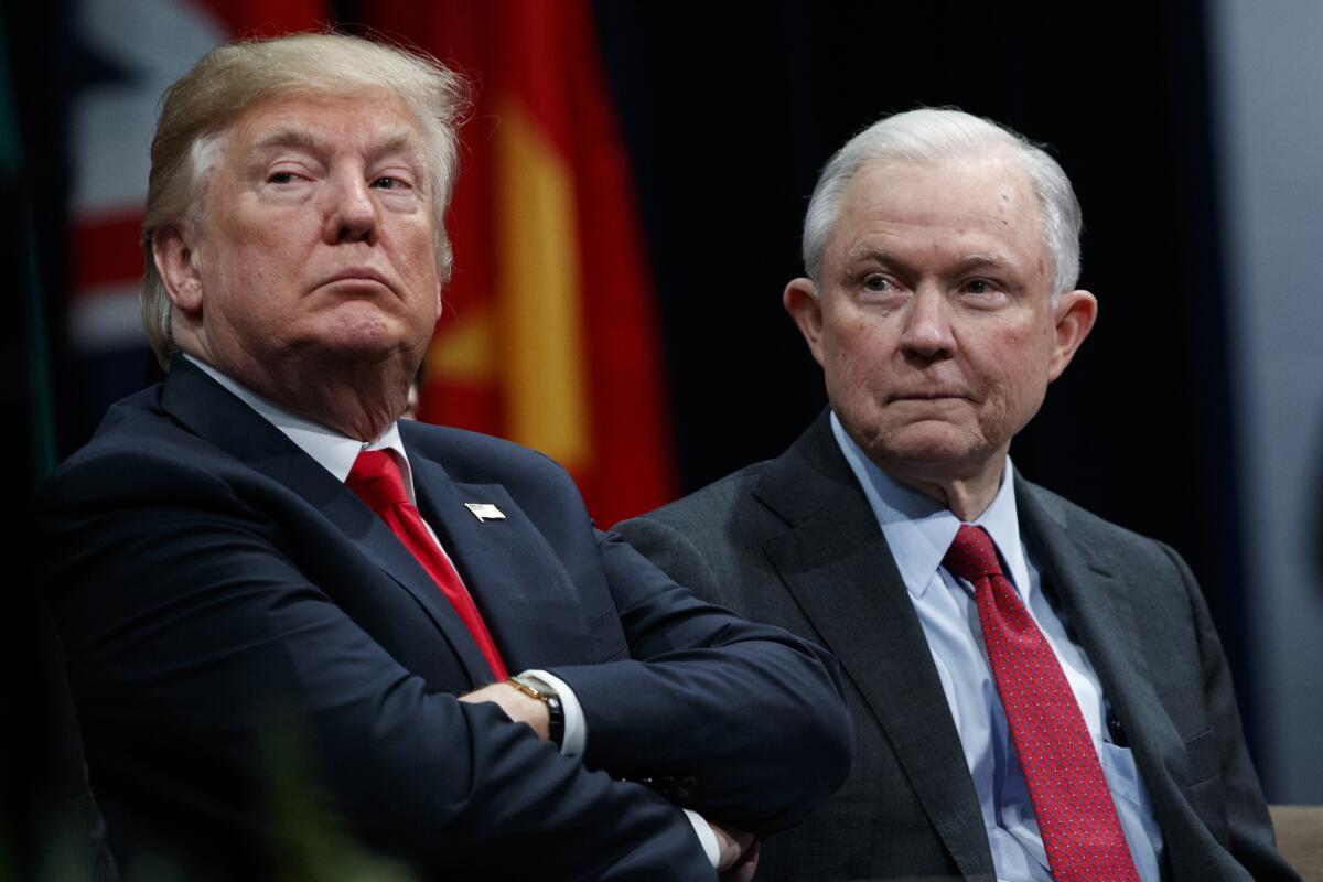 President Trump sits with Atty. Gen. Jeff Sessions during the FBI National Academy graduation ceremony in Quantico, Va., on Dec. 17, 2017.