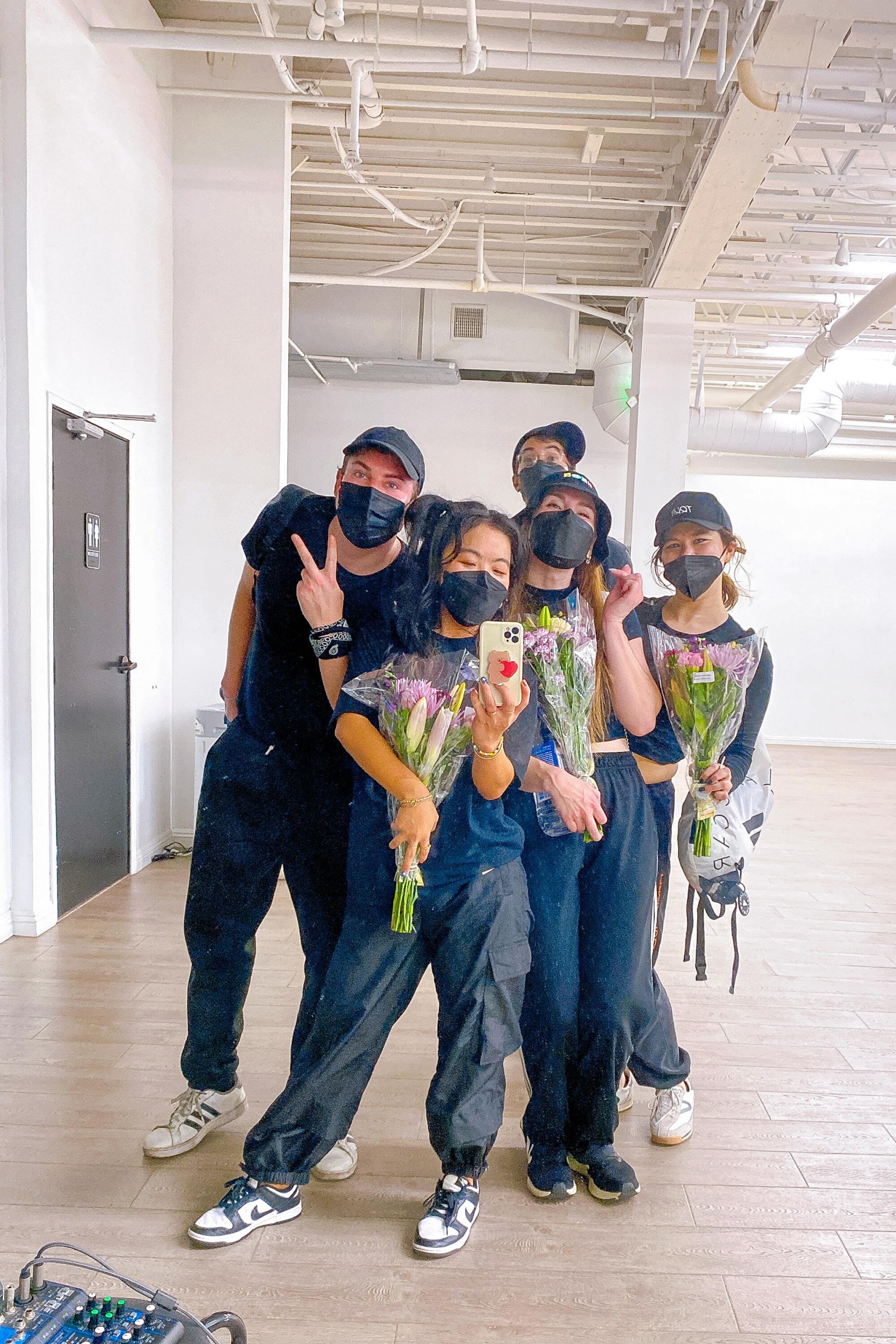 A group of people wearing masks.