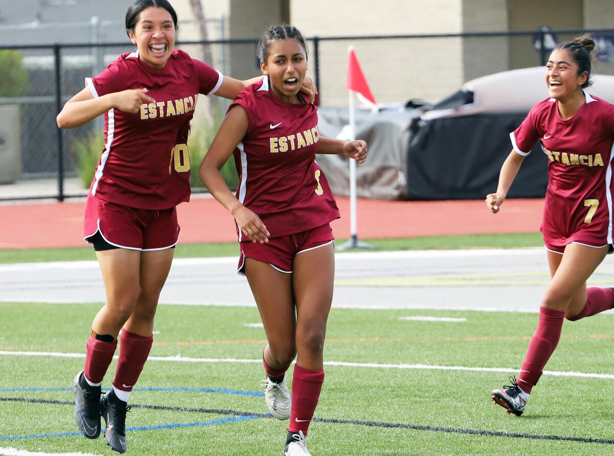 Estancia's Vanessa Pastrana (9), center, celebrates with her teammates after scoring the first goal of the match on Saturday.
