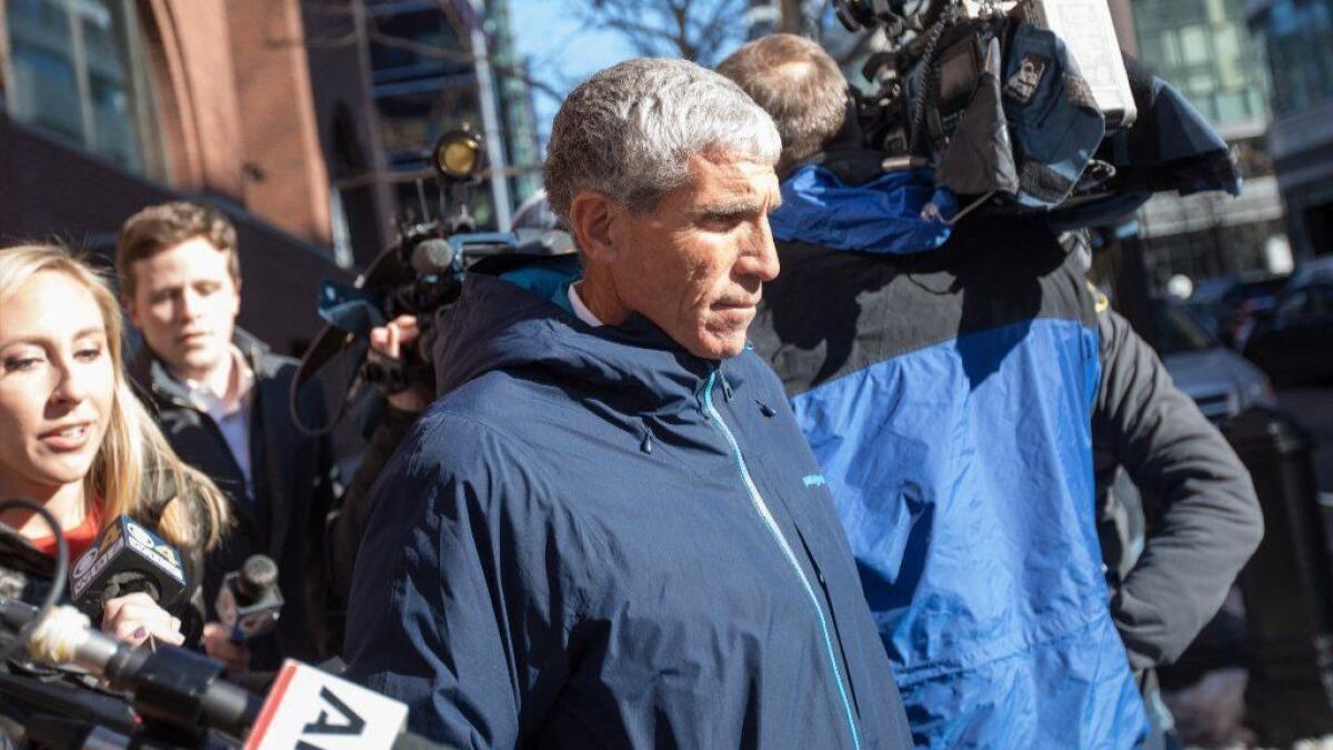 William "Rick" Singer leaves federal court in Boston on March 12. Two parents were indicted Tuesday for on charges of taking part in his college admissions scheme.