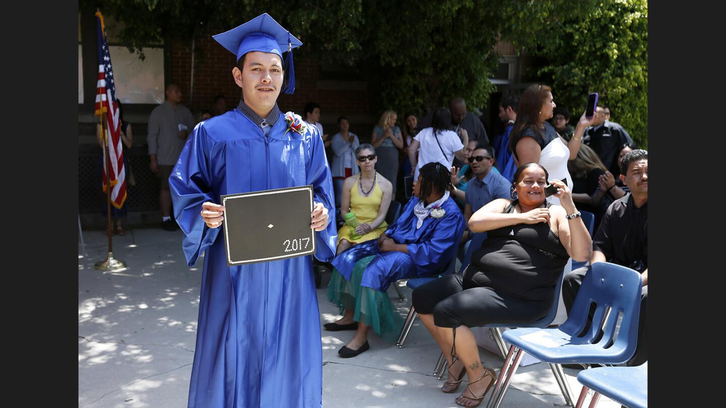 Victor Negrete shows off his diploma after graduation ceremony at Tobinworld in Glendale on Friday, June 9, 2017. Nine students participated in the graduation/culmination ceremony in front of family members, friends, teachers and fellow students.
