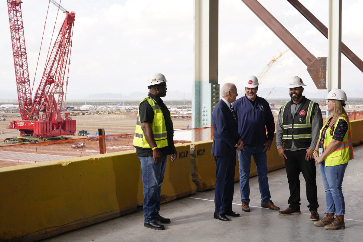 President Joe Biden tours the building site for a new computer chip plant for Taiwan Semiconductor Manufacturing Company, Tuesday, Dec. 6, 2022, in Phoenix. (AP Photo/Patrick Semansky)
