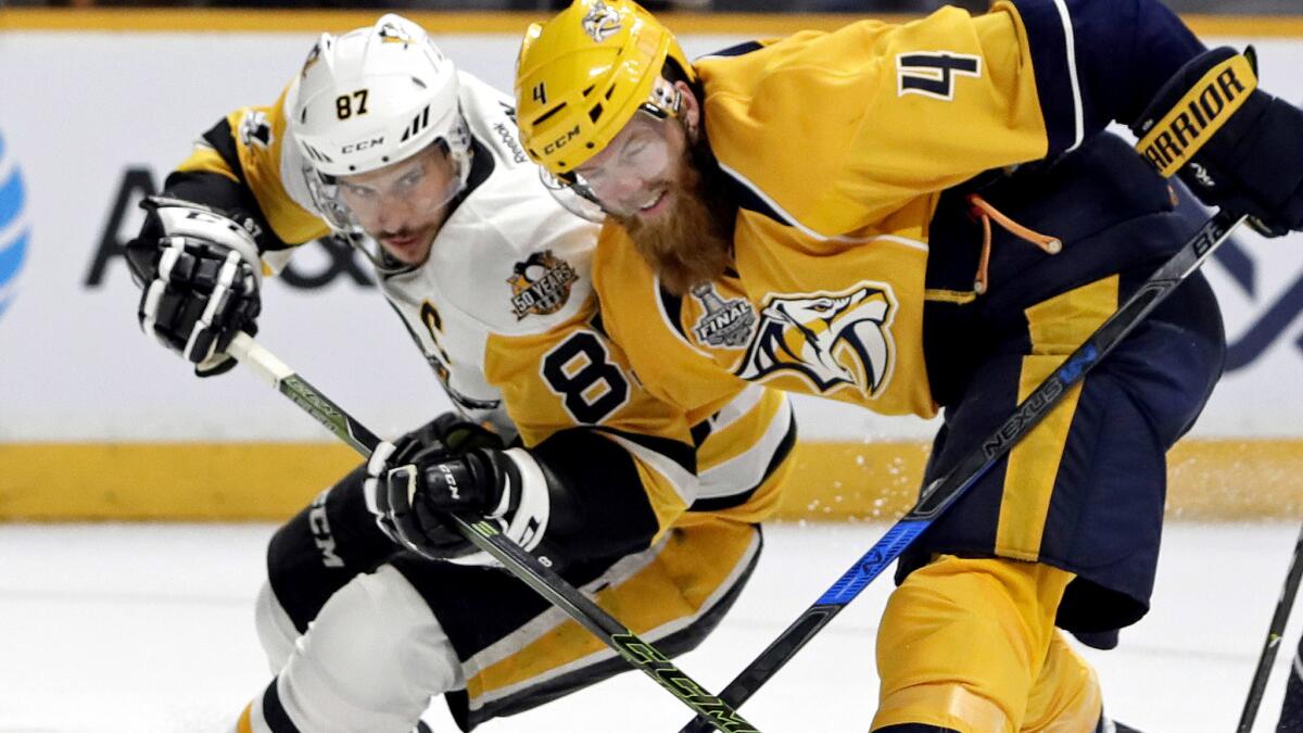 Predators defenseman Ryan Ellis (4) battles Penguins center Sidney Crosby (87) for position during a Stanley Cup Final game. Ellis is questionable for Game 6.