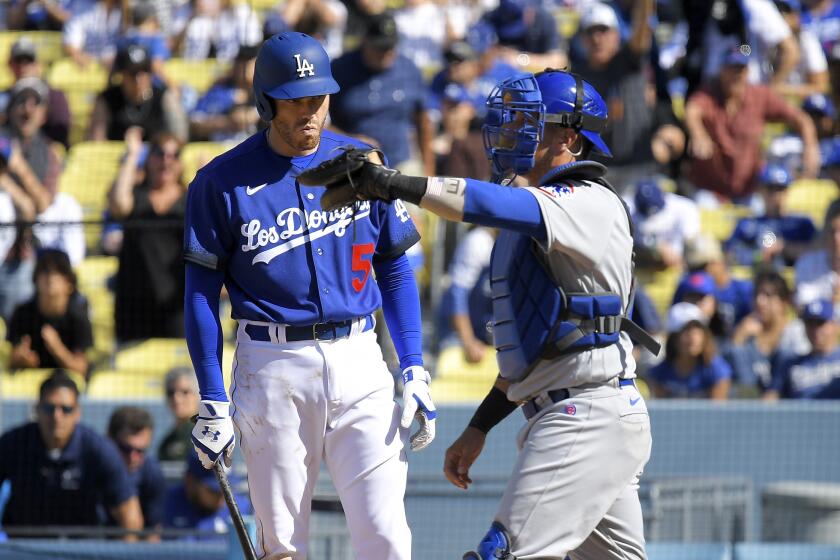 Chicago Cubs catcher Yan Gomes, right, celebrates after Los Angeles Dodgers' Freddie Freeman struck out to end the baseball game Sunday, April 16, 2023, in Los Angeles. The Cubs won 3-2. (AP Photo/Mark J. Terrill)