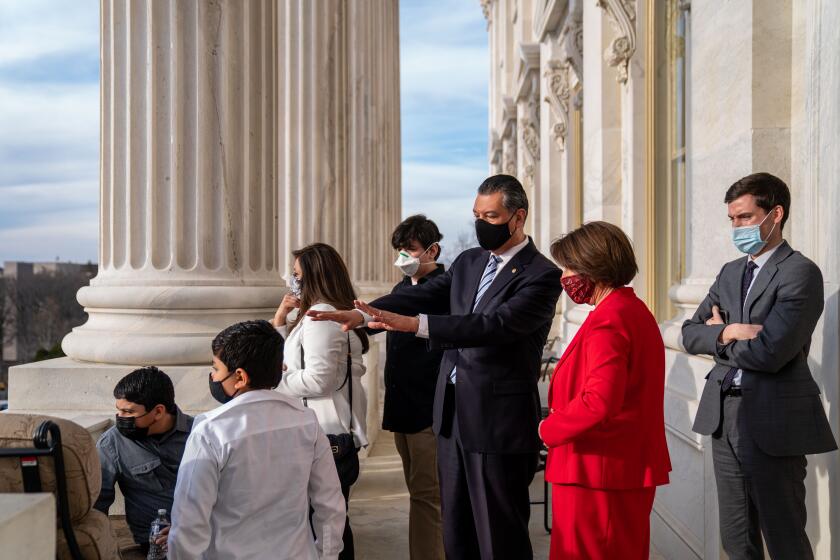 WASHINGTON, DC - MARCH 15: The Padilla family takes in the view of the National Mall from the Senate Majority Leader's Balcony as Sen. Amy Klobuchar (D-MN) gives Sen. Alex Padilla (D-CA) and family a tour of the offices of Senate Majority Leader Chuck Schumer (D-NY) on the Senate side of the U.S. Capitol Building following Padilla's first floor speech to the Senate on Capitol Hill on Monday, March 15, 2021 in Washington, DC. (Kent Nishimura / Los Angeles Times)