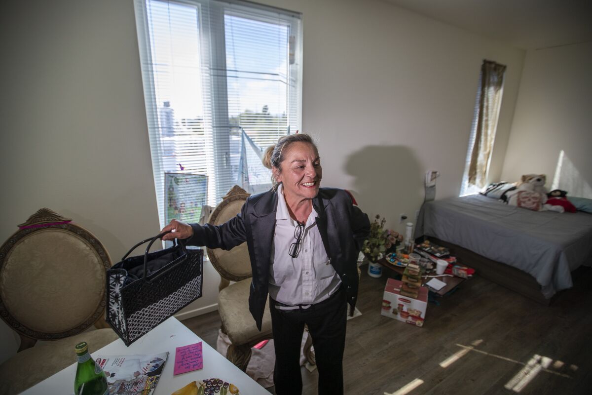 Rosa Duran shows off her new apartment in PATH Metro Villas, a supportive-housing development for homeless individuals