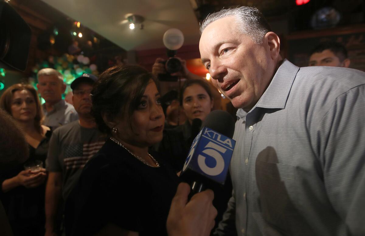 Los Angeles County Sheriff Alex Villanueva talks with reporters at a primary election night gathering.