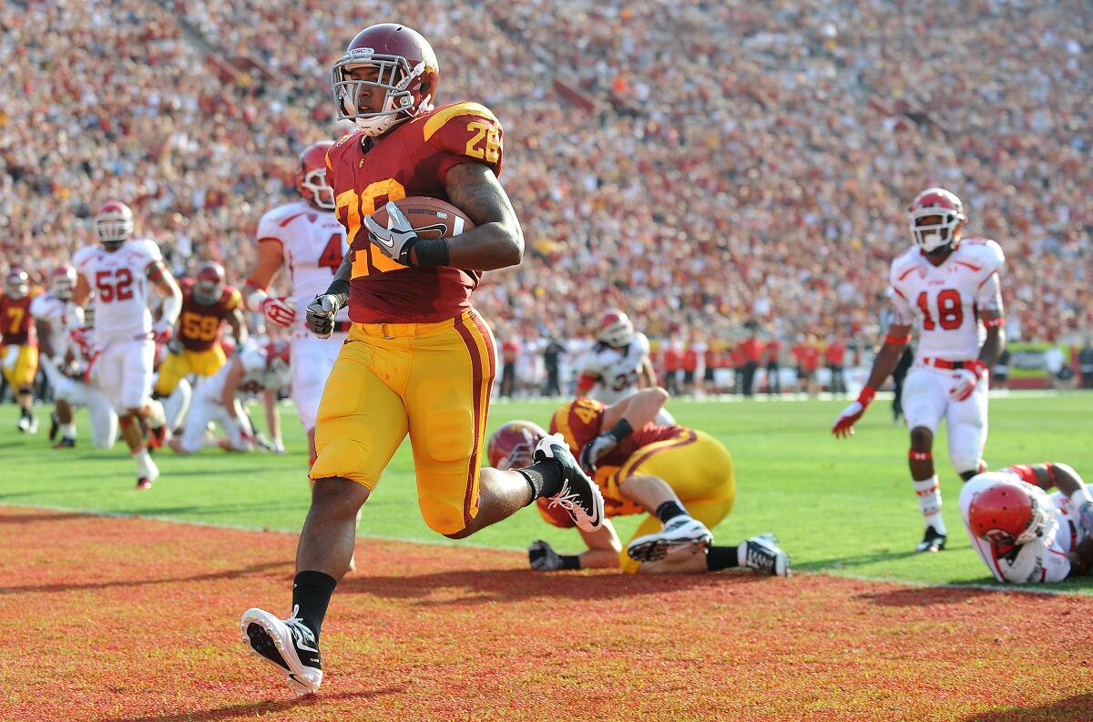 USC tailback Marc Tyler scores on a six–yard touchdown run against Utah in 2011.