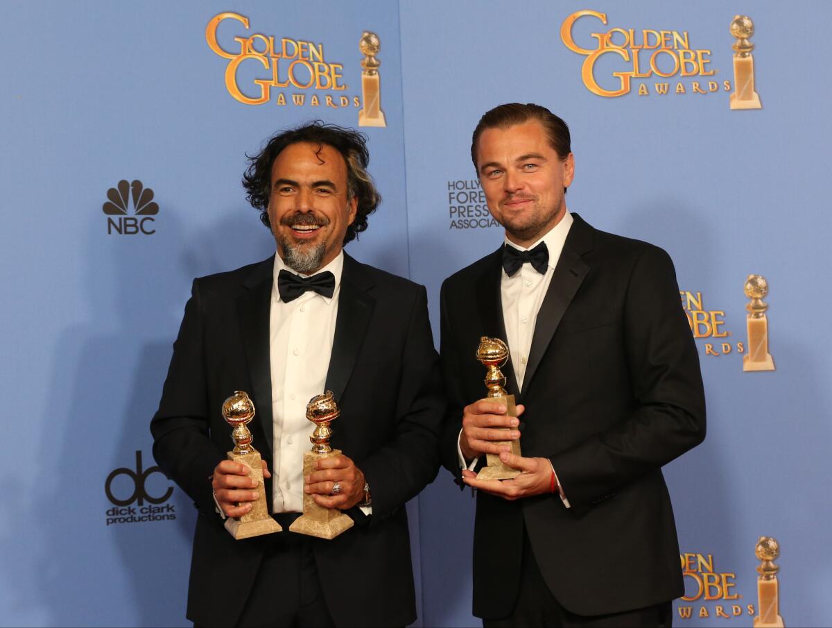 Director Alejandro González Iñárritu, left, and actor Leonardo DiCaprio pose with their awards for "The Revenant" in the press room at the 73rd Annual Golden Globe Awards.