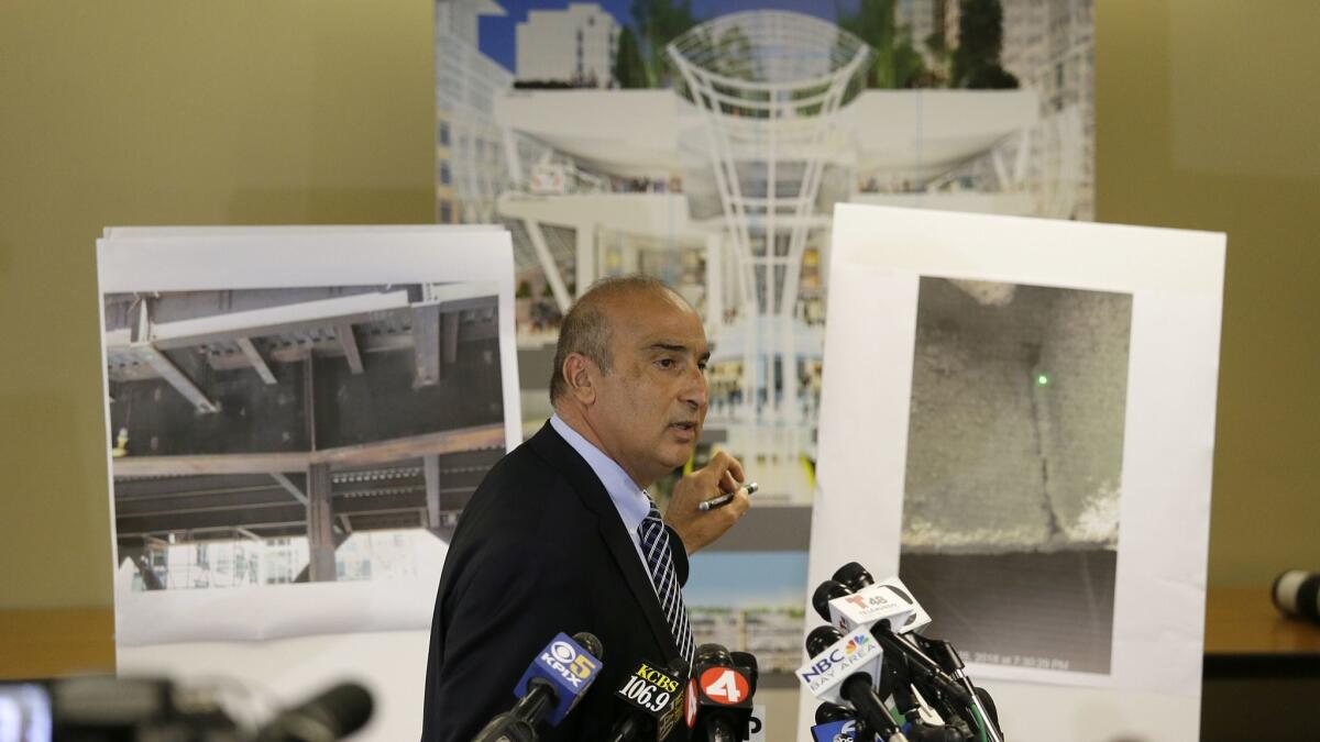 Mark Zabaneh, executive director of the Transbay Joint Powers Authority, points to a photograph showing a cracked steel beam found in the Salesforce Transit Center during a news conference Wednesday.