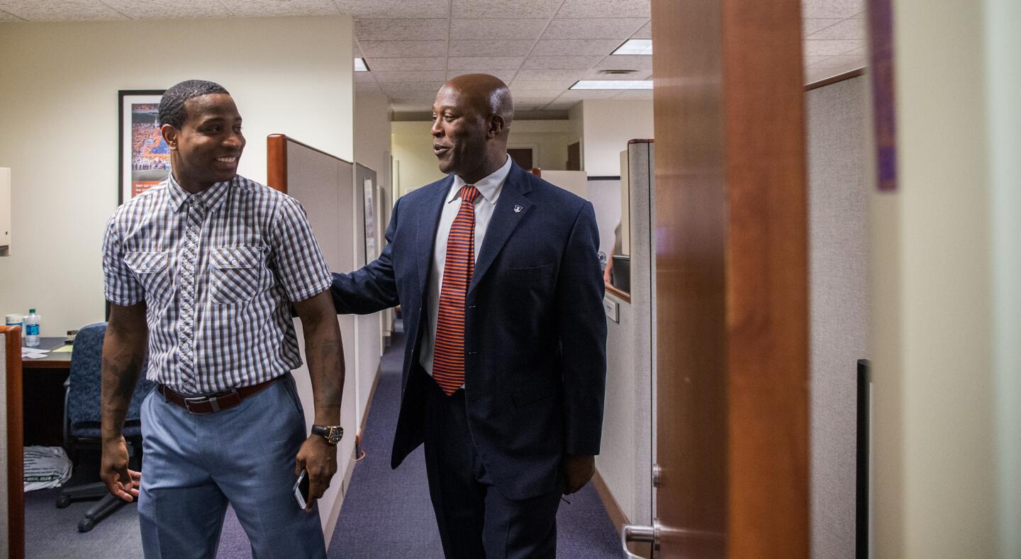 Ex-Bears coach Lovie Smith greets Dee Brown, special assistant to the athletic director, as he arrives at the Bielfeldt Athletics Administration Building in Champaign for an introduction as University of Illinois head football coach on March 7, 2016.