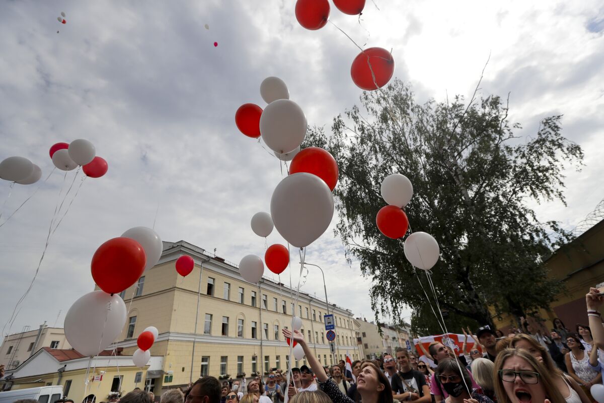 People release balloons in colors of old Belarusian national flag.