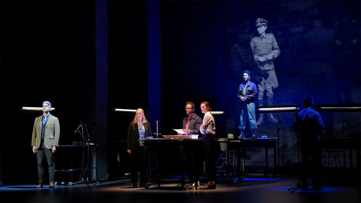 Four formed members connected a darkly lit stage.