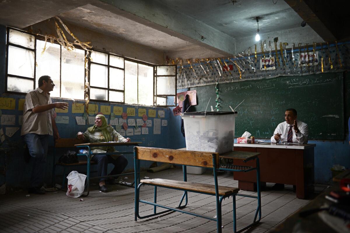 Employees wait for voters at a polling station in the Cairo suburb of Rod el Farag on May 27.