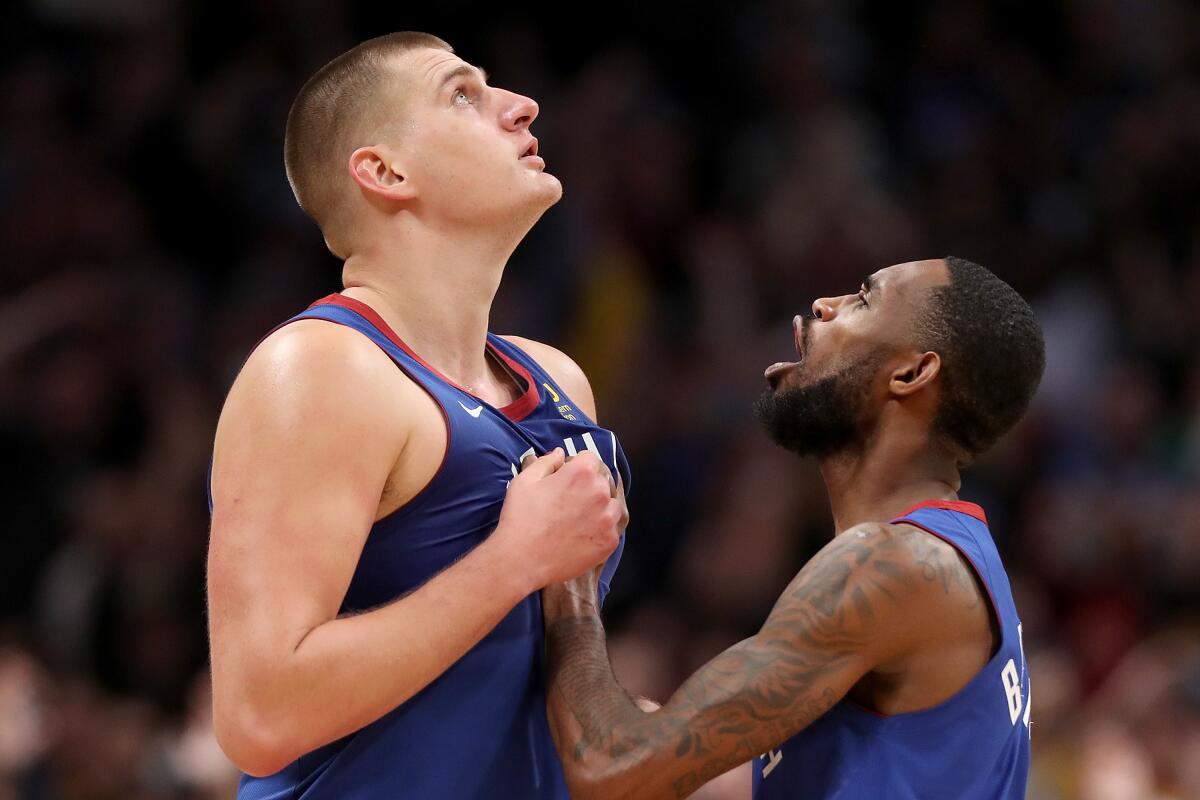 Denver Nuggets center Nikola Jokic, left, celebrates with guard Will Barton after hitting the winning basket in the final seconds against the Philadelphia 76ers on Nov. 8.