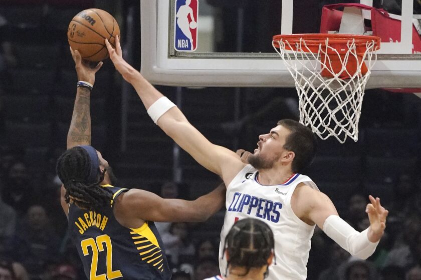 Indiana Pacers forward Isaiah Jackson, left, has his shot blocked by Los Angeles Clippers center Ivica Zubac during the first half of an NBA basketball game Sunday, Nov. 27, 2022, in Los Angeles. (AP Photo/Mark J. Terrill)