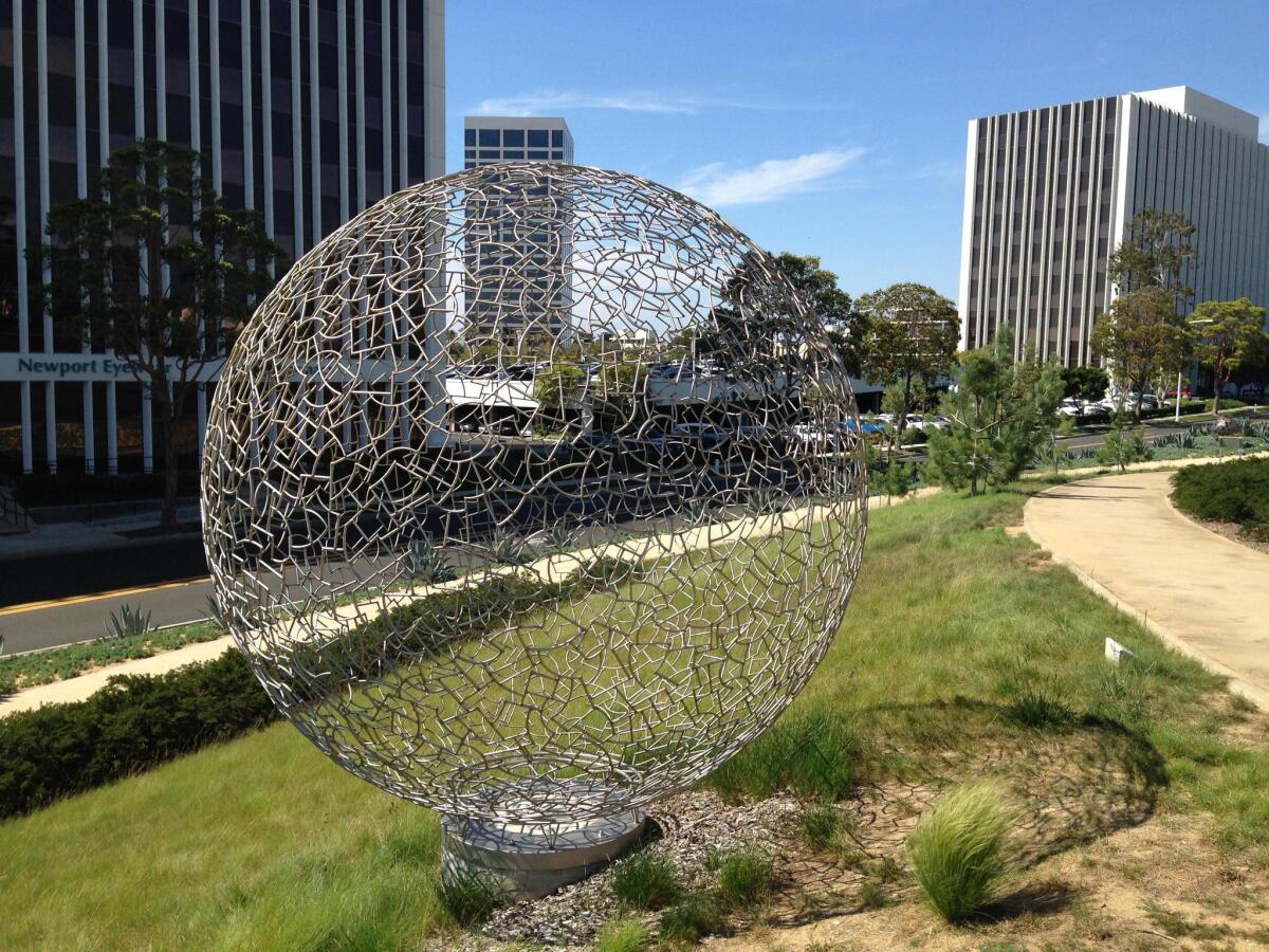 “Sphere 112” sits on the path leading to the dog park at Newport Beach’s 14-acre Civic Center Park. The local arts foundation has agreed to buy the piece from artist Ivan McLean for $15,000 and donate it to the city.