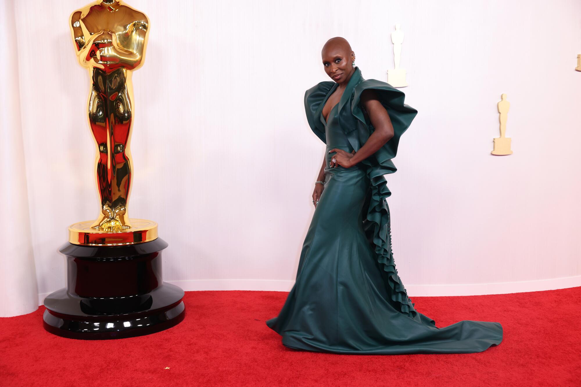 Cynthia Erivo wears a green leather gown. 