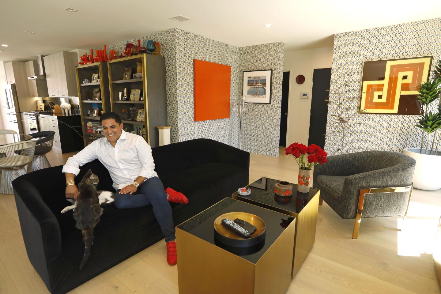 NORTH HOLLYWOOD, CA - AUGUST 13, 2019 - - Reza Shah, realtor and star of BravoÕs, "Shahs of Sunset," reclines in his home with his cats Bugsy and Peet, foreground, in North Hollywood on August 13, 2019. (Genaro Molina / Los Angeles Times)
