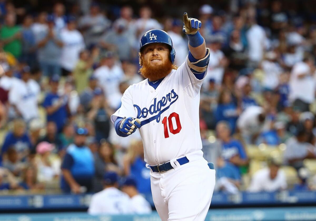 Dodgers' Justin Turner points to the stands after hitting a home run against San Diego on Saturday.