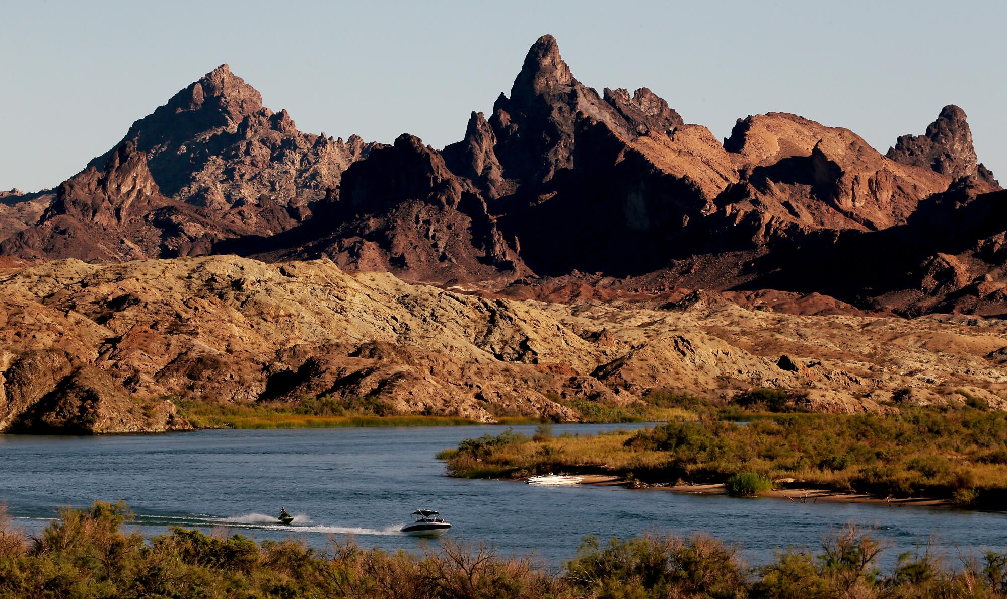 A speedboat and a personal watercraft on the Colorado River.