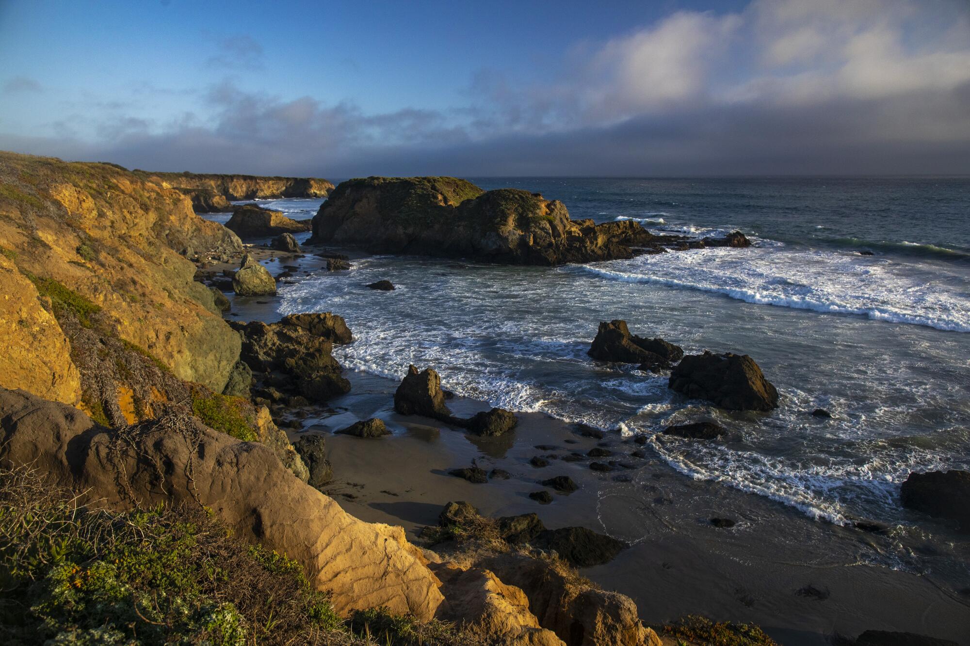 A rocky stretch of coastline and surf.