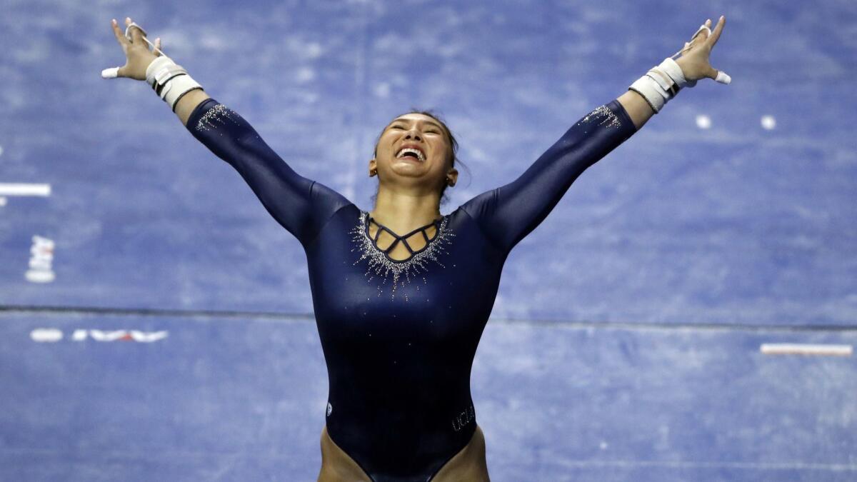 UCLA's Kyla Ross smiles after completing her routine on the uneven parallel bars during the NCAA women's gymnastics championships in April 2018.
