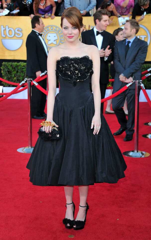 Emma Stone's black Alexander McQueen dress, in a mid-calf length, looks young and fresh.