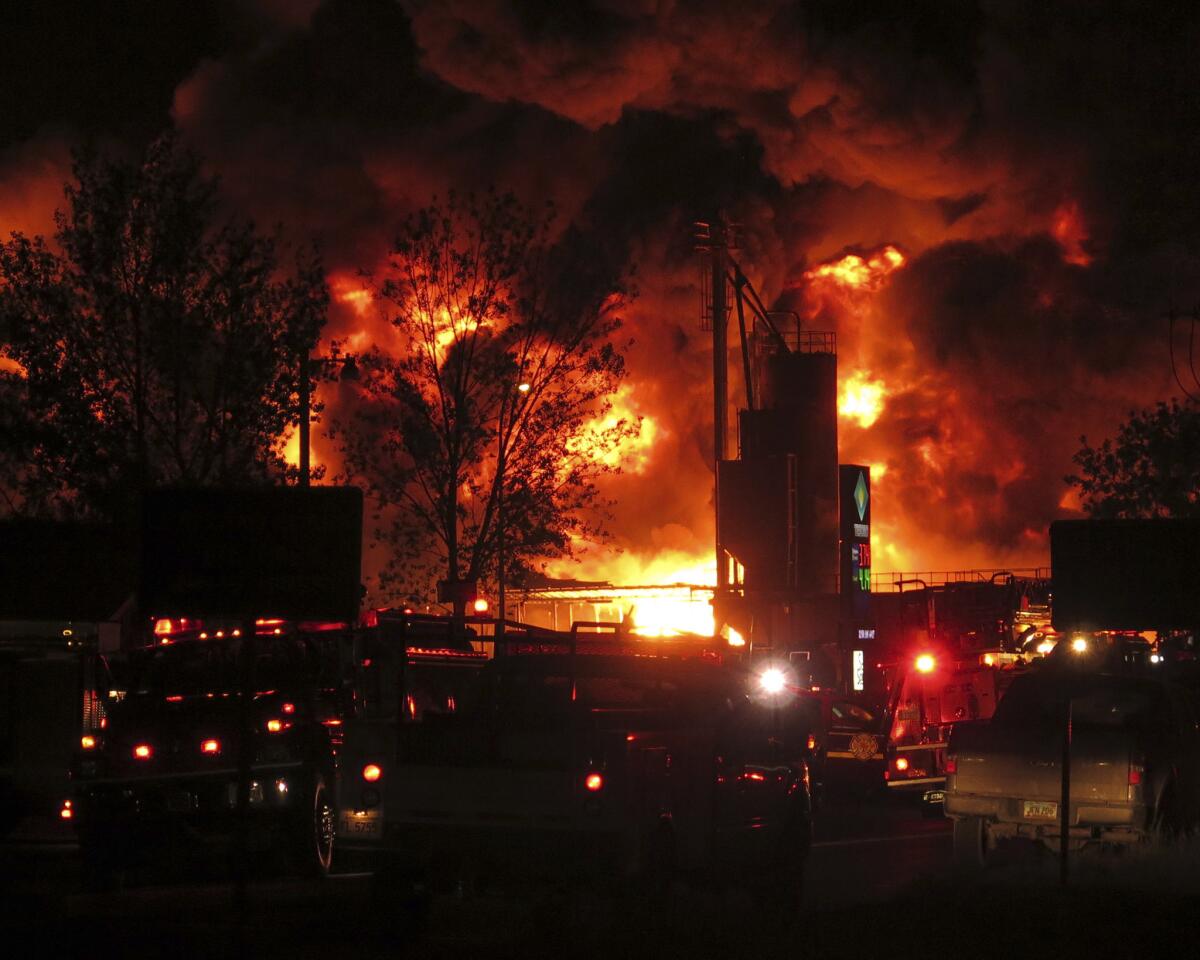 Emergency vehicles respond to a fire at Red River Supply, an oil supply company, in Williston, N.D., early Tuesday.