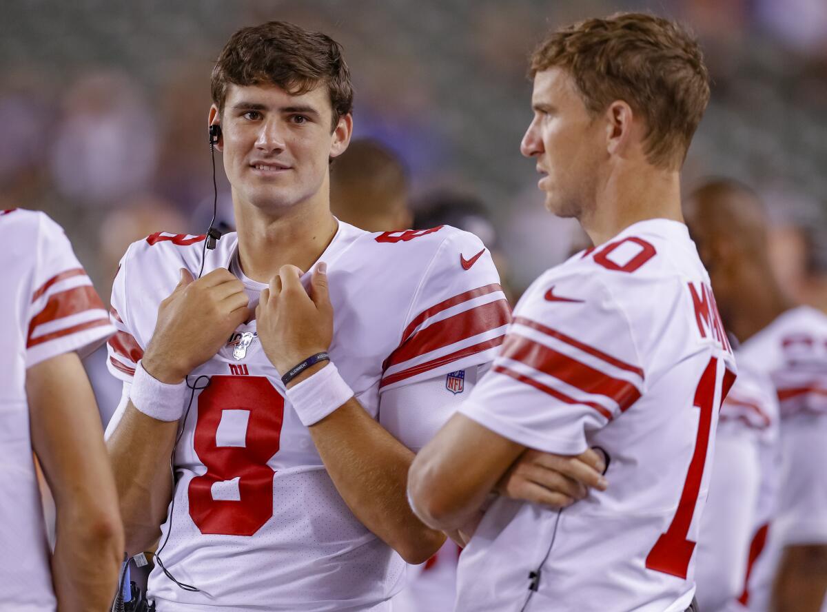 Rookie Daniel Jones, left, has been named the New York Giants' starting quarterback, replacing two-time Super Bowl MVP Eli Manning.