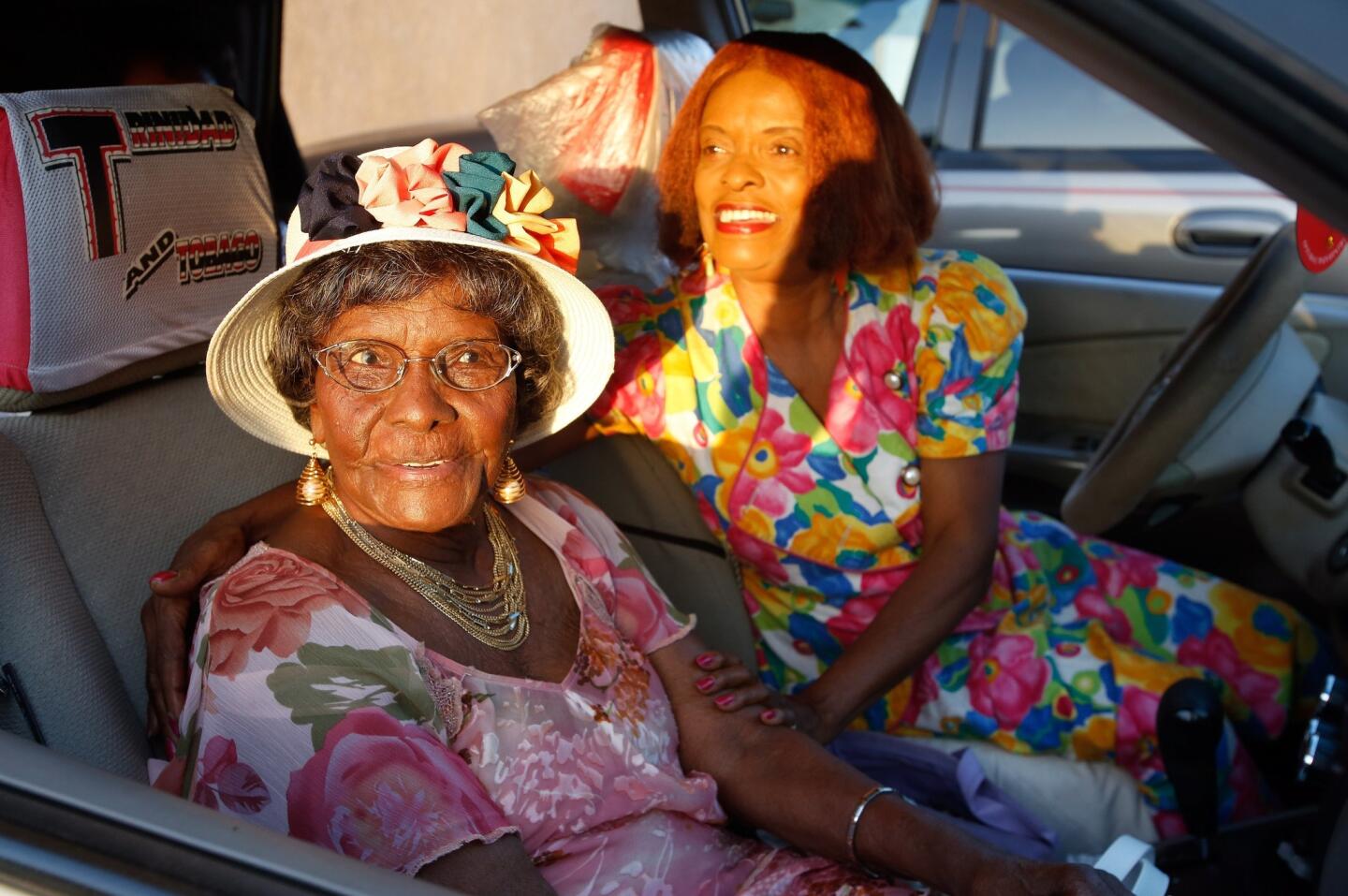 Emelia De-Four, 99, waits in the parking lot with her daughter Ruphina Allen, 74, before going on a shopping spree at the 99 Cents Only store in Paramount on Friday. De-Four recently turned 99.