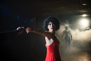 A woman dances in a red dress.