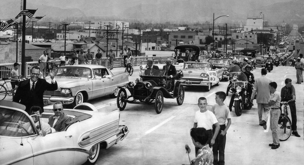 Aug. 12, 1958: Burbank Mayor Dallas Williams, left, waves from front of caravan that officially opens the city's new $1.6 million Olive Avenue Bridge.