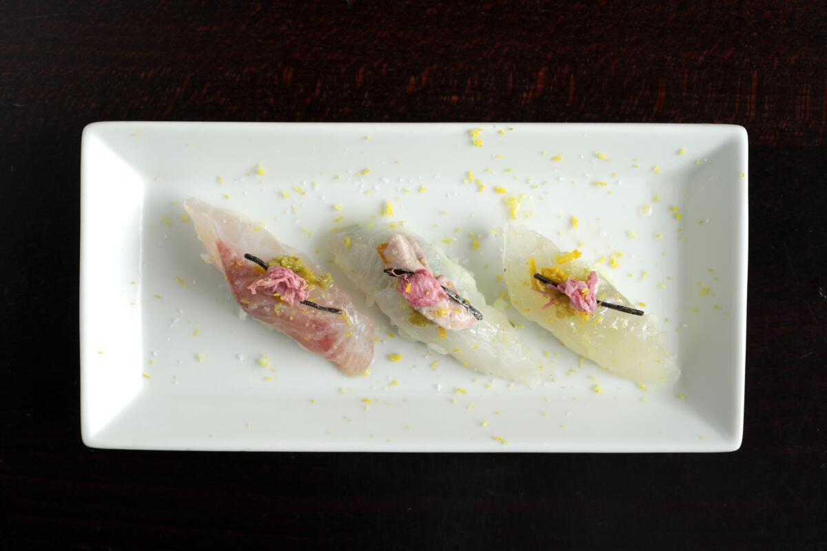 Mejina (large-scale blackfish), triggerfish and kelp-marinated halibut topped with cherry blossom, a seasonal garnish Tsuyoshi Kawano occasionally uses.