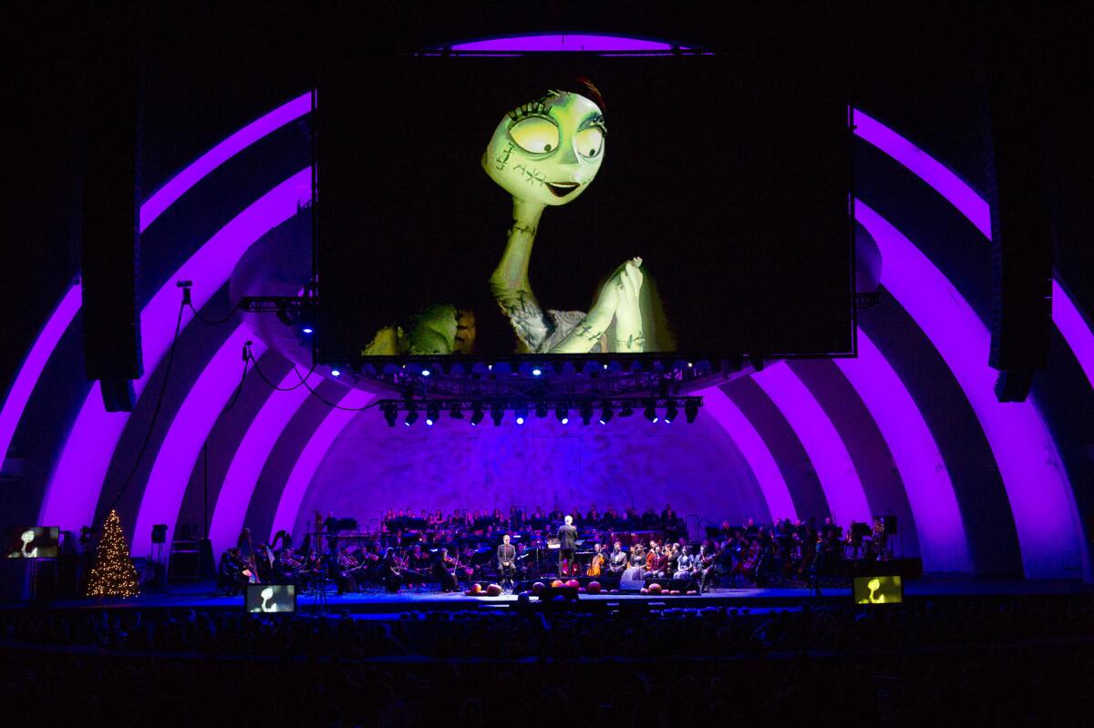Screens show the movie "The Nightmare Before Christmas" during Danny Elfman's concert at the Hollywood Bowl on Oct. 31.
