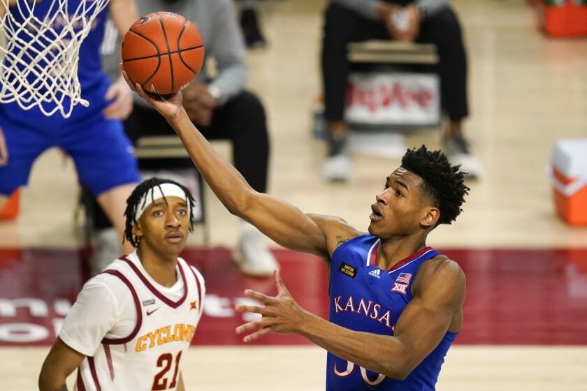 Kansas guard Ochai Agbaji drives to the basket in front of Iowa State guard Jaden Walker, left, during the second half of an NCAA college basketball game, Saturday, Feb. 13, 2021, in Ames, Iowa. Kansas won 64-50. (AP Photo/Charlie Neibergall)