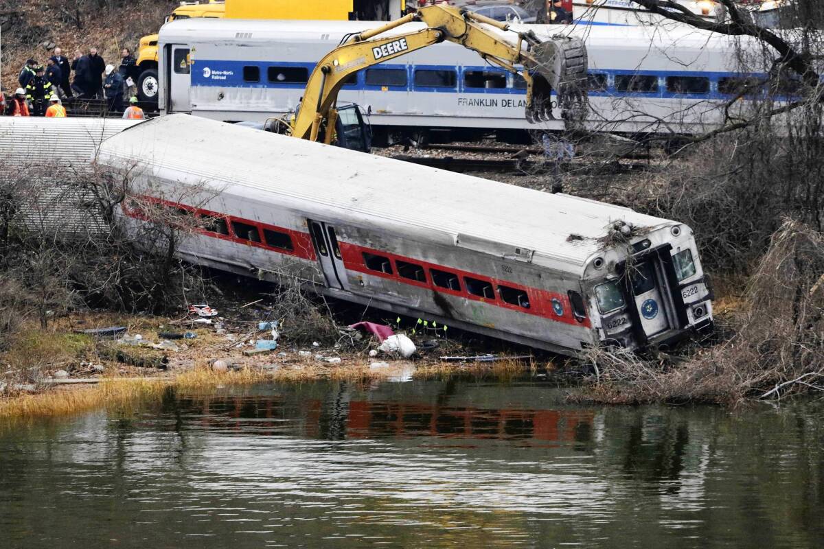 Federal authorities begin righting the seven cars of a passenger train that derailed early Sunday in the Bronx borough of New York. Investigators say the train was going 82 mph on a 30-mph curve.