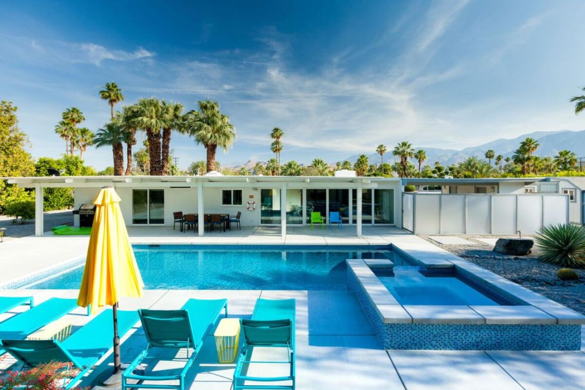 A white low-slung home with a pool in Palm Springs.